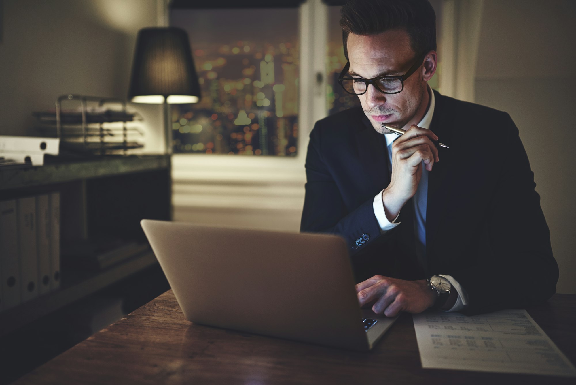 Serious businessman working on laptop