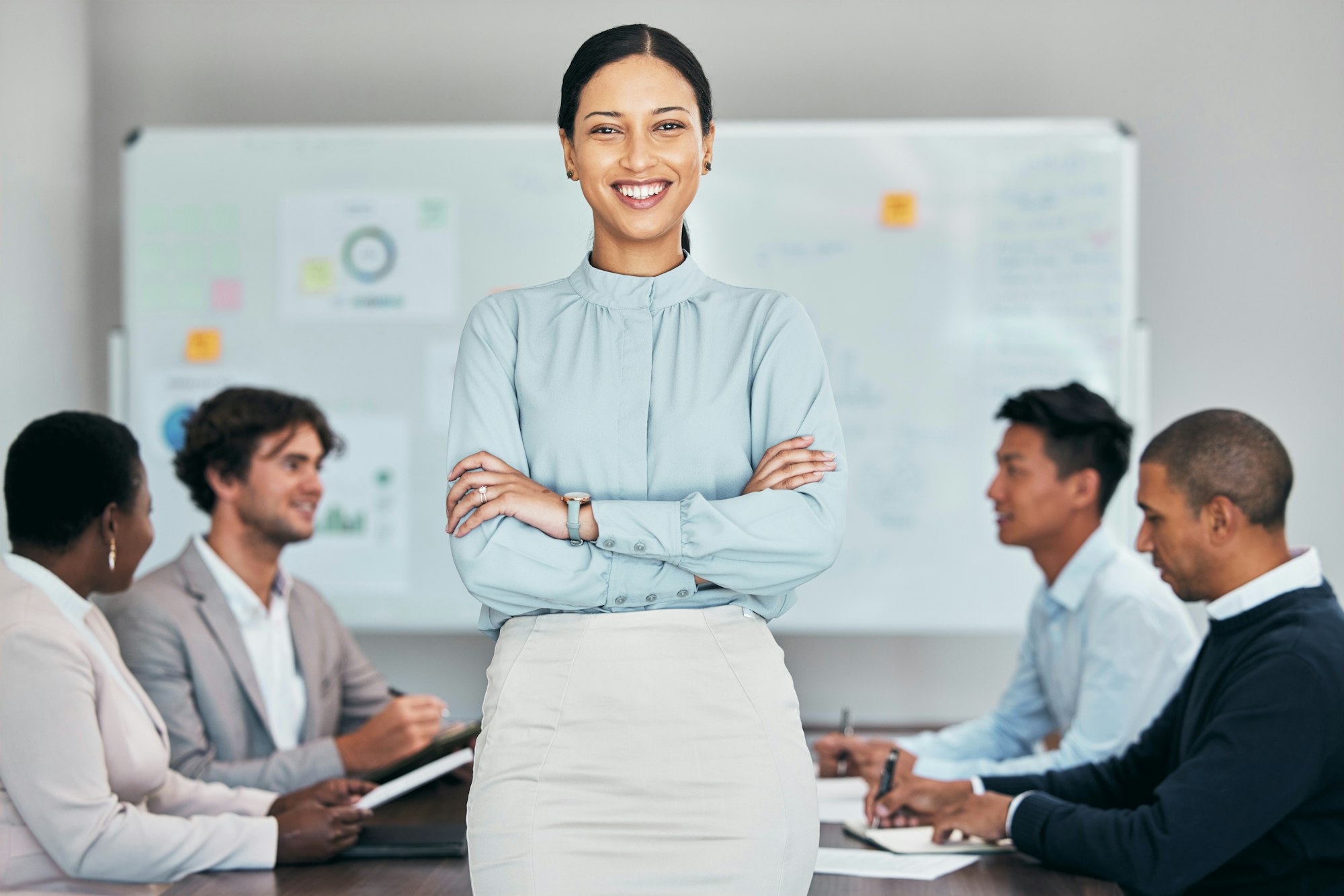female team leader manager or boss standing confident with support of hard working employees staf