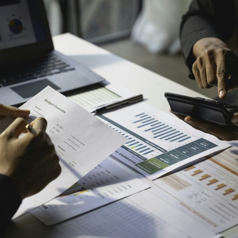 Teamwork with business people analysis cost graph on the desk in the meeting room. The business team