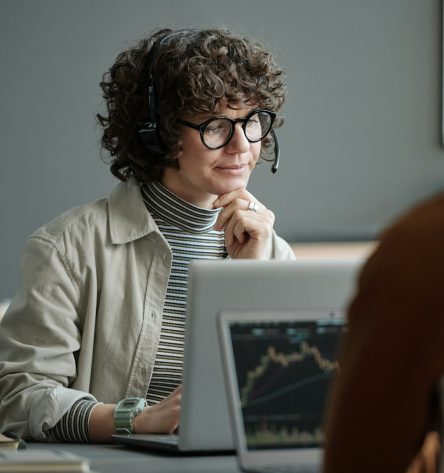 Young confident female IT support manager listening to online client